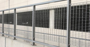 Aluminum bar grating panels near a parking garage structure