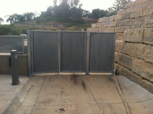 An outdoor entrance blocked off by 3 vertical louver panels