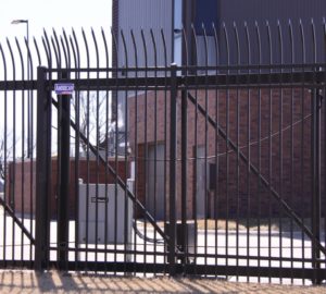 An American Fence Company access control operated ornamental iron cantilever gate