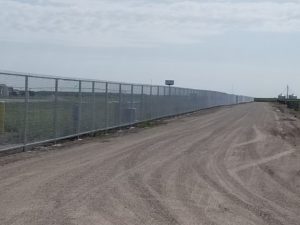 A long row of security chain link fencing installed by American Fence Company at Husker Harvest Days. This chain link fence has top and bottom rail for ultimate security