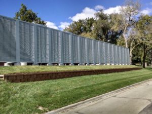 Horizontal louvered panels installed as an outdoor barrier wall