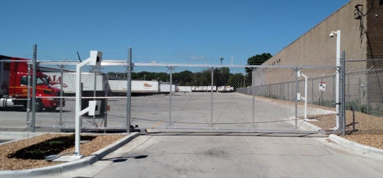 High security chain link cantilever gate with barb wire and automated access controls