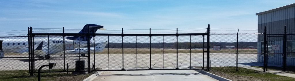 Airport fly grounds secured by high security ornamental cantilever sliding gate with barb wire and automated technology