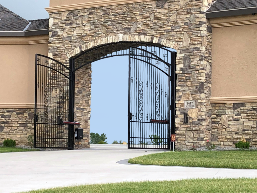 Double swing ornamental gates with gate operator at a personal residence. Rochester fence company fence contractors Minnesota gates automation repair gate operator residential commercial