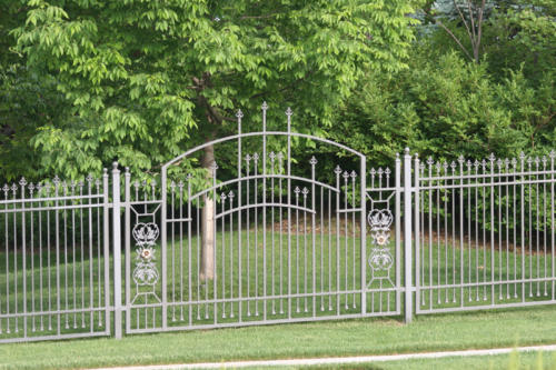 6-8 foot tall ornamental off-white iron fence with large overscalloped gate