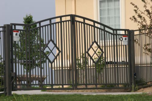 6-10 foot tall decorative flat overscalloped double swing gate with diamond-shaped accents in the left-center / right-center of each gate