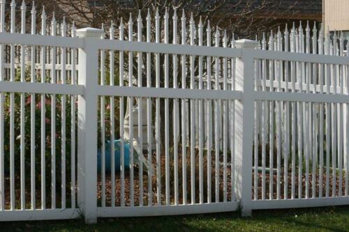 6-8 foot tall white ornamental iron fence with small pointed spires of varying heights on top of each rod creating an over-scalloped design