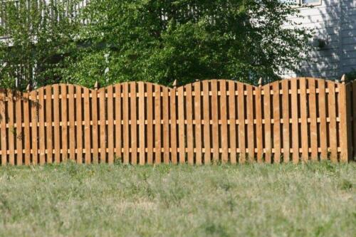 6-8 foot tall overrscalloped pattern shadowbox wooden fence with similarly styled single swing gate