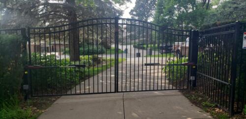  6 - 8 foot tall black arched automated swing gate