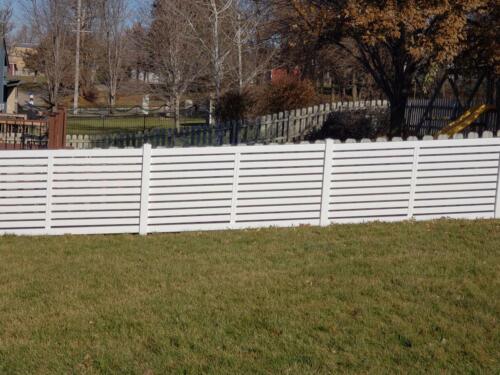 5-8 foot tall white vinyl fence with planks facing horizontally