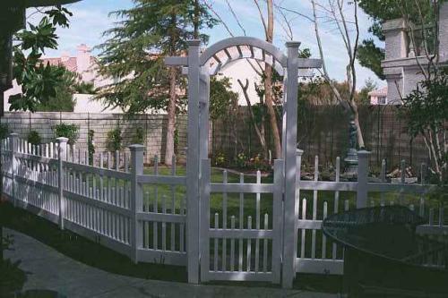 3-5 foot tall decorative white fence with a 6-8 foot white archway above a narrow white gate