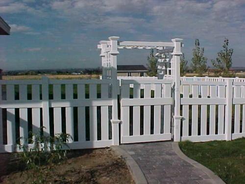 4-6 foot tall white fence with 5-7 foot white boxed archway overhang