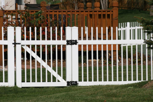 4-6 foot tall white ornamental iron fence with very small pointed spires of uniformed heights on top of each rod