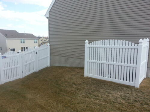 6-8 foot white vinyl picketed fence with an over-scalloped cut
