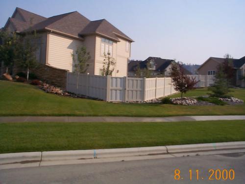 6-8 foot tall shadow-boxed vinyl fencing with an exterior horizontal plank in the middle connecting fencepost to fencepost