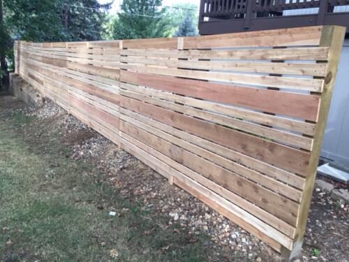 6-8 foot tall horizontal semi-private wooden fence with hidden off-colored posts