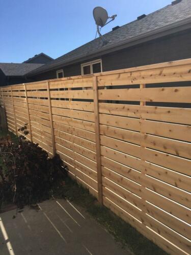 6-8 foot tall horizontal wooden fence with wooden vertical fence posts