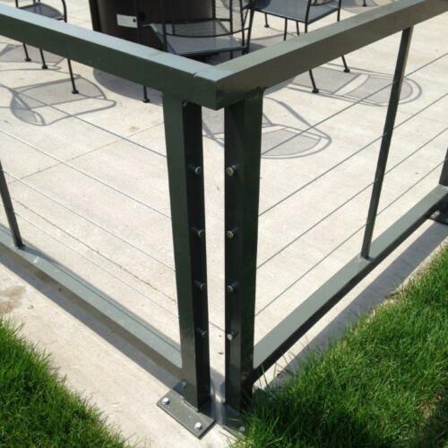 3 - 4 foot tall black metal handrails enclosing outdoor dining area - close up