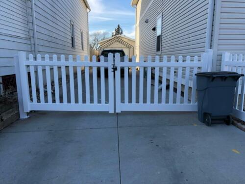 3-5 foot white picket manual double swing gate with a 2-5 inch gap between each plank