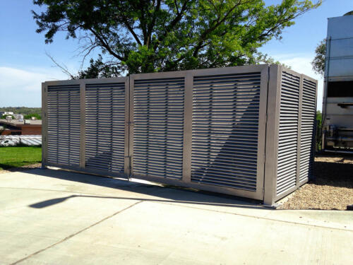 6-8 foot grey louvers on cement creating an enclosure