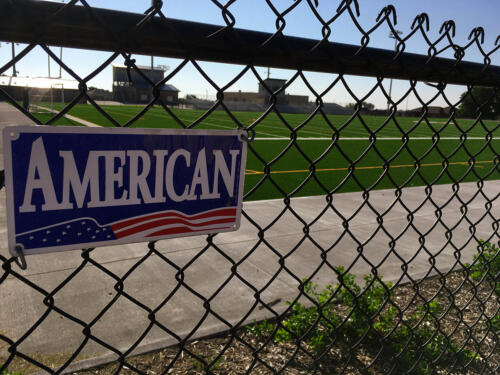 4 - 8 foot black chain link fence that encloses a football field