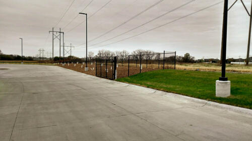 6 - 8 foot black woven and welded wire fence creating a partial enclosure
