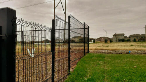 6 - 8 foot black woven and welded wire fence creating an enclosure