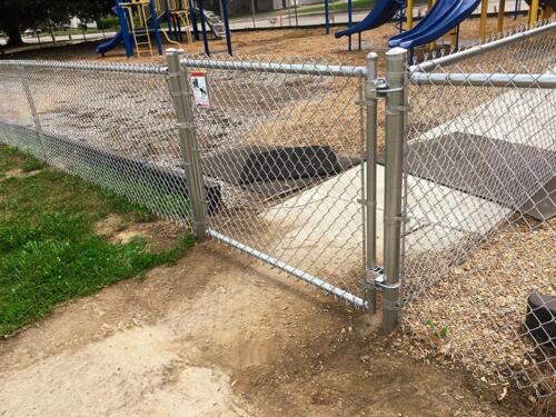 3-5 foot grey chain link fence enclosing a playground