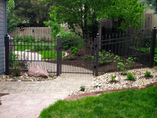 4 - 6 foot tall black custom ornamental fence with arched swing gate