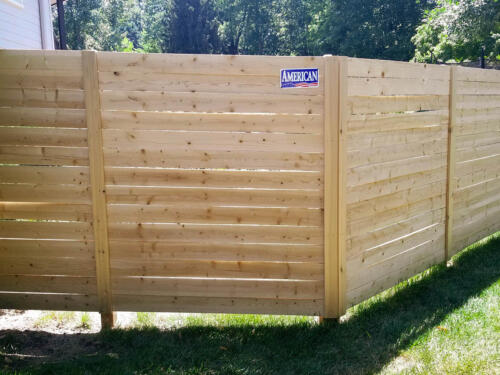 6-8 foot tall semi-private wooden fence with same color vertical fence posts