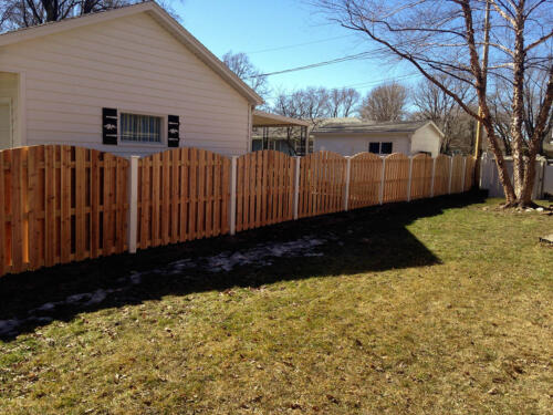 6-8 foot tall shadow box overscalloped wooden fence with white vinyl fence posts 