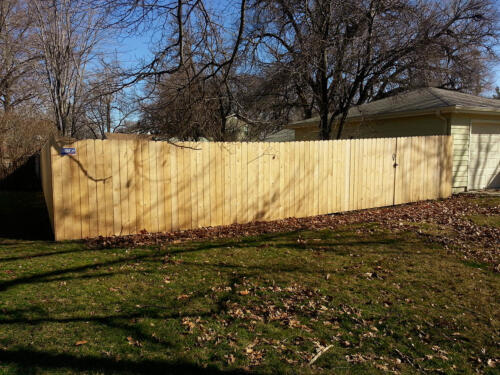 5-7 foot tall wooden privacy fence enclosing a yard