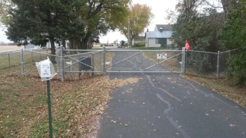3 - 5 foot tall grey chain link automated swing gate