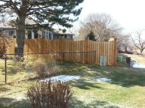 6-8 foot tall semi-privacy fence with underscallop post to post. Fence posts have square beveled tops 