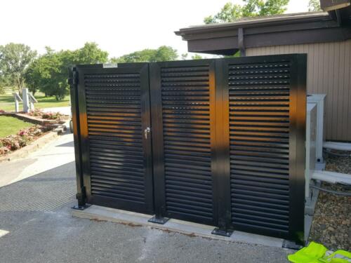 6-8 foot black louvers on cement creating a partial enclosure