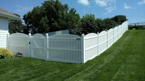 6-8 foot white vinyl picketed fence with an over-scalloped cut