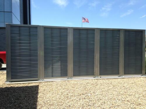6-8 foot grey louvers on cement creating an enclosure
