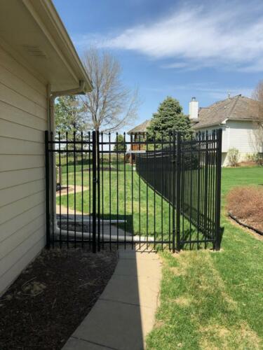 6 - 8 foot tall black ornamental fence with manual swing gate
